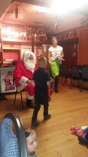 Santa presenting Euan with present Santa presenting Euan with present